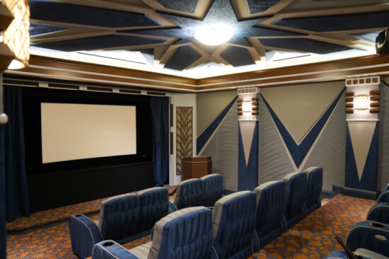 The couple's home theater has plush seating and a popcorn machine.