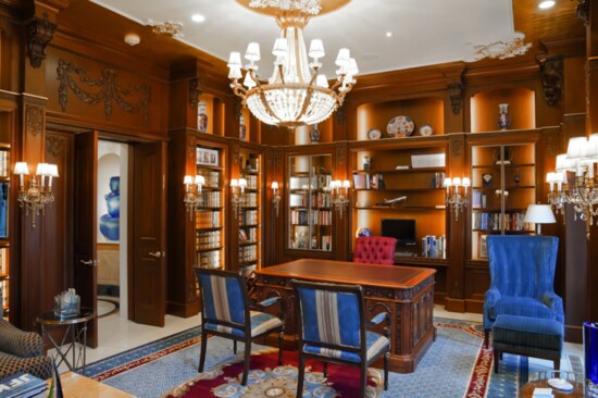 The mahogany-laden library features a replica of the USS Resolute Desk used by presidents at the White House. 