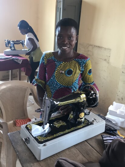 Wo Ye Bra trainee smiling because she just unveiled her brand new sewing machine.