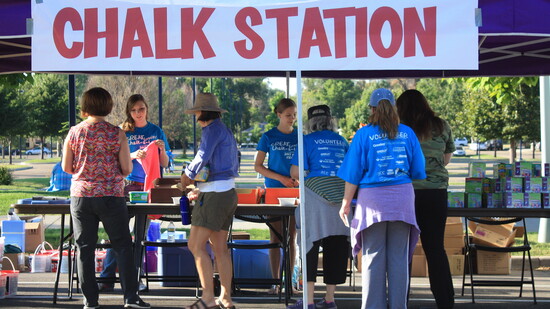 Volunteers check in participants for Greeley's successful attempt at breaking the Guinness Book of World Record's longest continuous chalk walk drawing in 2015