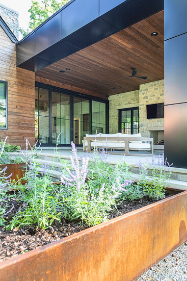 Wood planters contain greenery next to the Bloomfield Hills home's loggia.