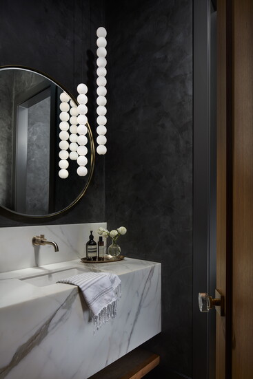 Honed Calcutta marble anchors a muted powder room.