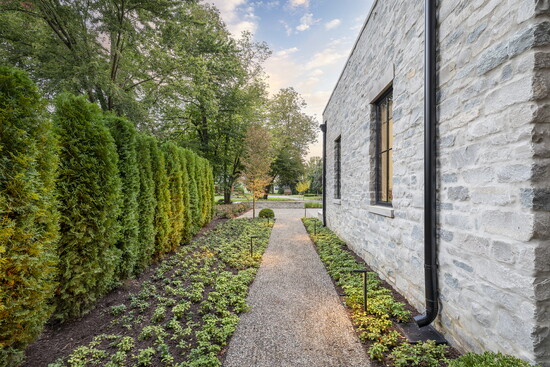 A lit pathway leads to the back of the house.