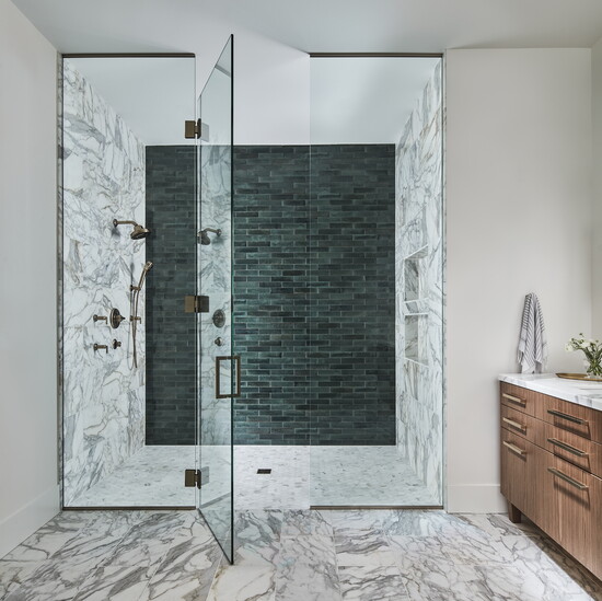 A beautiful blend of honed Calcutta marble and a handmade custom subway tile creates a serene master bath retreat.