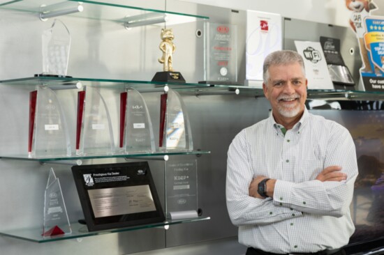 Dave Listul with his dealership's awards on display