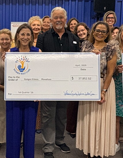 From left, Nicole Campon, Teresa White, Roy Young and Angie Ray celebrate a community donation to HUM.