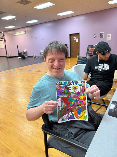 Villager Nick Gentry posing with one of his many original art pieces.