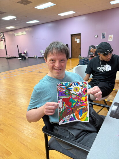 Villager Nick Gentry posing with one of his many original art pieces.