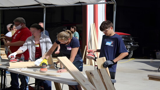 Hands-on teamwork: Sleep in Heavenly Peace volunteers build a bed.