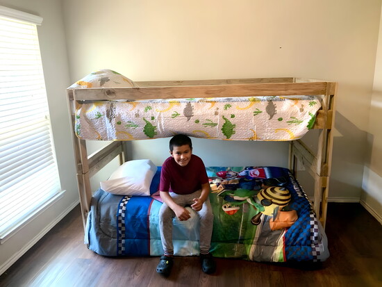 A child settles into his Sleep in Heavenly Peace bunk bed.