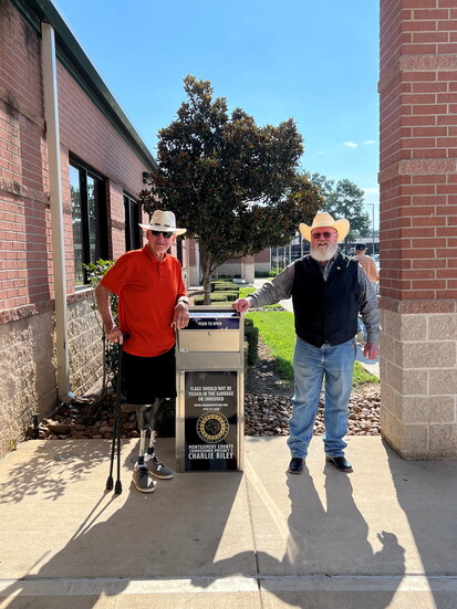 Commission Chairman Jimmie C. Edwards III and Precinct 2 Commissioner Charlie Riley pose at the park's U.S. flag retirement box.