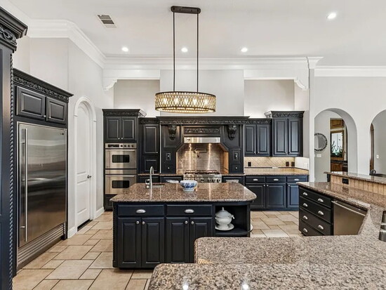 The gourmet kitchen delivers the ultimate culinary experience with a Sub‑Zero refrigerator, Viking professional range, custom cabinetry, and stone counters.
