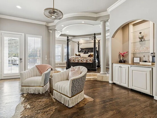 The primary suite is a sanctuary featuring a cast‑stone fireplace, a private sitting area, and a dry bar for morning coffee.