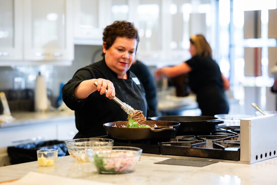 Chef Carrie Walters teaches home chefs at the DLM Culinary Center the steps for making a pan sauce in her recent La Dolce Vita Supper Club class. 