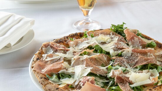 The Bianca pizza topped with prosciutto and baby arugula.