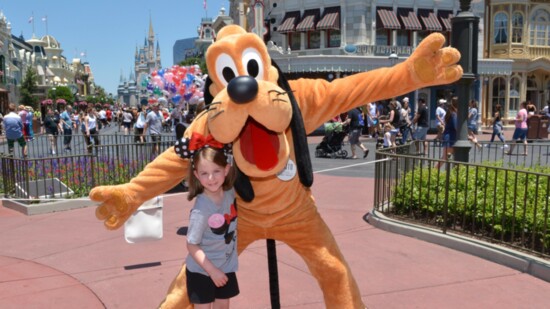 Scarlett with Pluto at Disney World. 