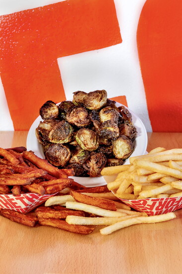 Sides include fries and crispy Brussels sprouts