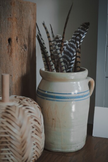 Great-gradmother's butter churn filled with pheasant feathers.