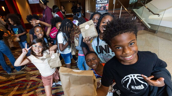Students enjoy Snack Packs after their field trip. (Photo by Chris Savas)