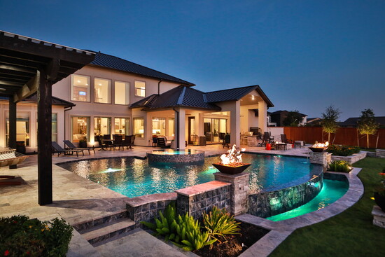  Backyard oasis–the shimmering pool, elevated spa, outdoor lounge, and private dock all framed by lush green lawn. 