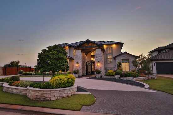 Sweeping driveways and a gated entrance enhance privacy while showcasing the home’s modern curb appeal. 