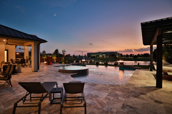 Expansive patios, a sparkling pool, and a private dock all highlight the luxury lakeside lifestyle.
