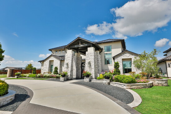  The wide driveway and stone accents highlight its presence in the community.