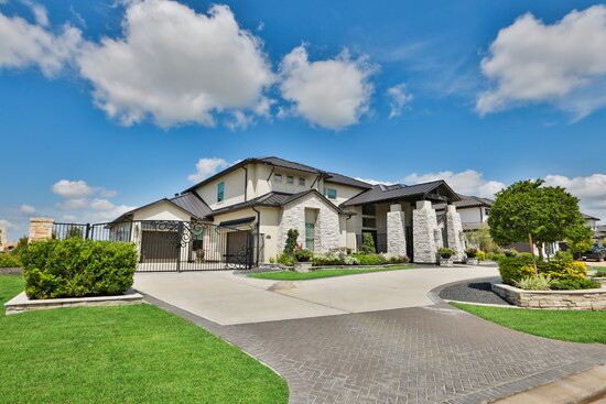  The wide driveway and stone accents highlight its presence in the community.