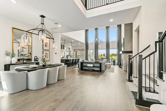 Soaring ceilings, two-story wall of windows, open layout that flows effortlessly. Natural light fills the space, creating a bright and airy atmosphere.