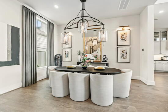  Elegant dining space with statement chandelier, sleek neutral finishes, and a cozy yet sophisticated layout– the perfect spot to share meals and memories.