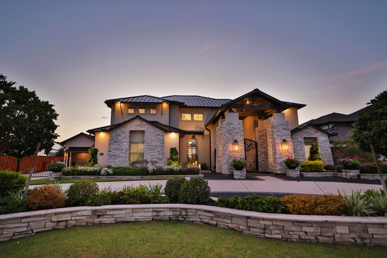 Sweeping driveways and a gated entrance enhance privacy while showcasing the home’s modern curb appeal. 