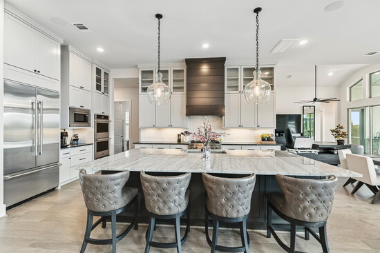 The open-concept layout connects the living room, dining area, and kitchen in seamless style, making everyday living feel extraordinary.