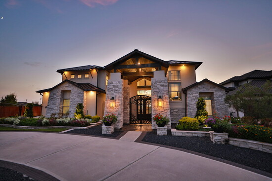 Sweeping driveways and a gated entrance enhance privacy while showcasing the home’s modern curb appeal. 