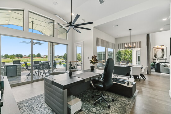 This flexible living area doubles as a stylish workspace, with dramatic barn doors that slide open to reveal the media room.