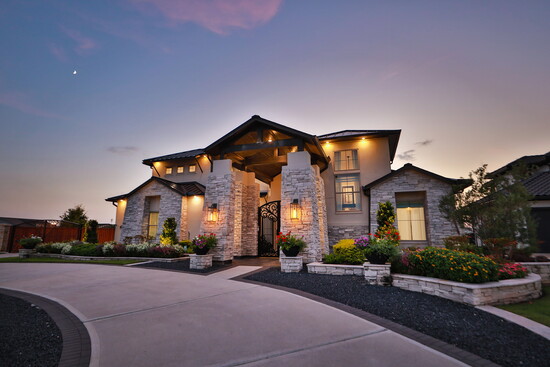 Sweeping driveways and a gated entrance enhance privacy while showcasing the home’s modern curb appeal. 