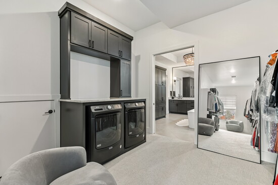 The convenience of in-closet laundry adds everyday ease to this luxury space.
