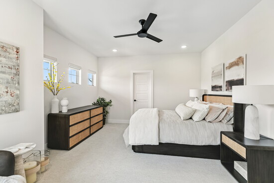 This spacious third bedroom feels bright and serene with its clean design and natural light from high-set windows.