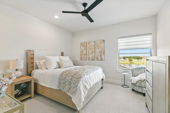 This upstairs 5th bedroom offers calming water views, creating a peaceful retreat for guests. 