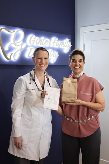 Ericka Lyman delivering one of her signature homemade cookie boxes to Dr. Jessica Ginter