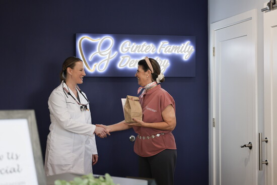 Ericka Lyman delivering one of her signature homemade cookie boxes to Dr. Jessica Ginter