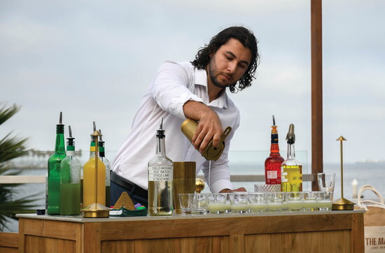 Mixologist Preston Crespo pours cocktails during a Fuego media event.