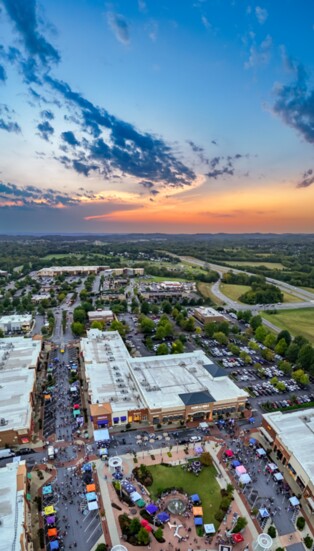 The Sun sets over a large crowd at the Taste of Hendersonville.