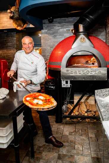 Vittorio Lanni in front of Trattoria's oven