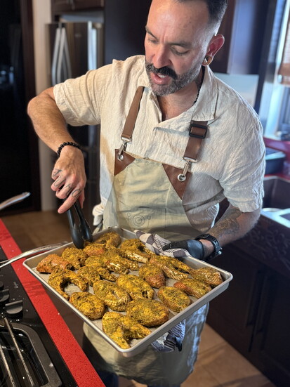 Chef Xavi of The Xperience seasoning snapper