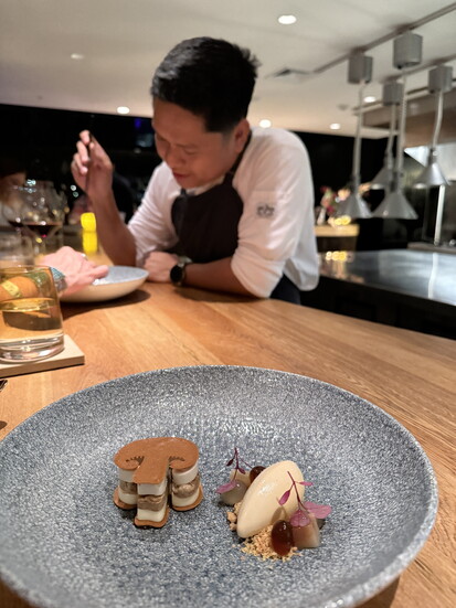 Sous chef explaining dessert at Infini