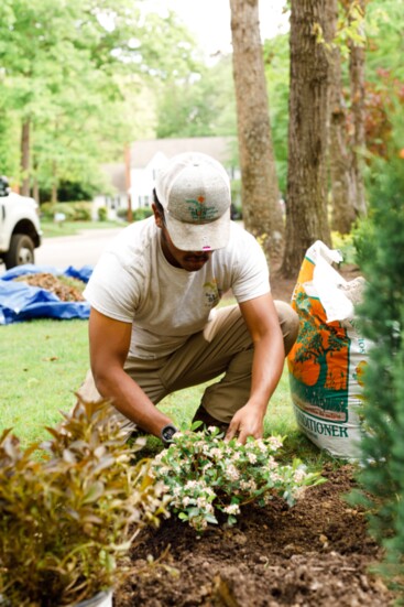 Dedicated Southern Sun Landscaping employee Andres Montiel works diligently on a customer's lawn.