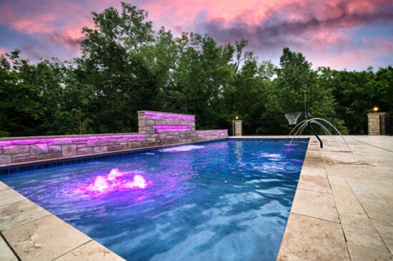 Travertine pool decking and customized LED lighting give the entire backyard a resort-like feel.