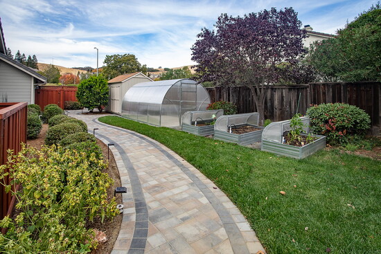 dditional enhancements include custom planter boxes and a greenhouse, enriching the landscape while providing practical benefits.