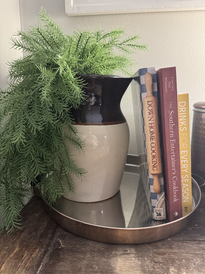 Combine new and old like new cookbooks with an antique pitcher. 