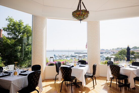 The elegant 1852 Grill Room’s floor-to-ceiling windows and outdoor patio give way to a gorgeous bay view. 